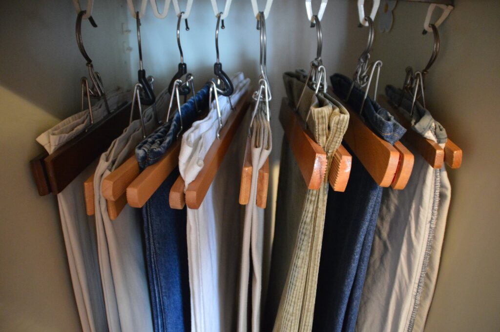 Group of pants hanging in the closet